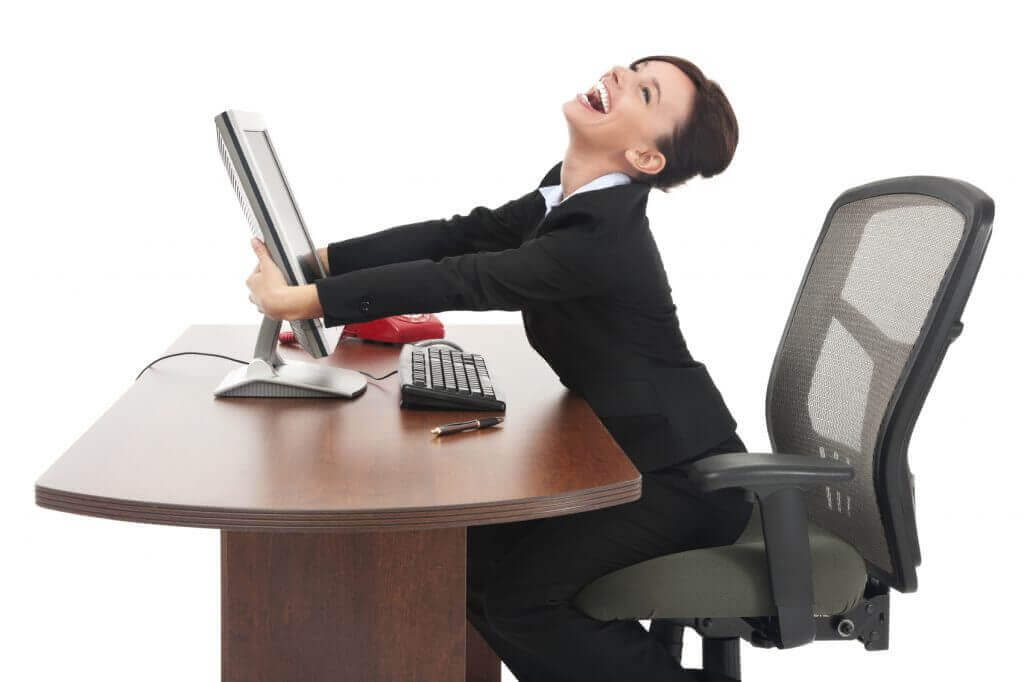 lady holding her computer cheering as she starts to see her hotel bookings come back