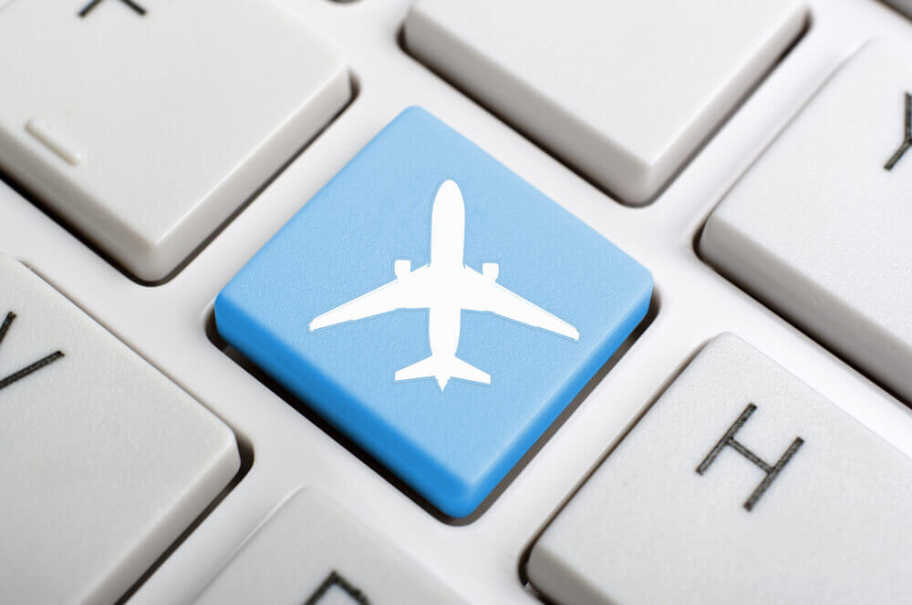 keyboard with a blue key with an image of a plane in flight