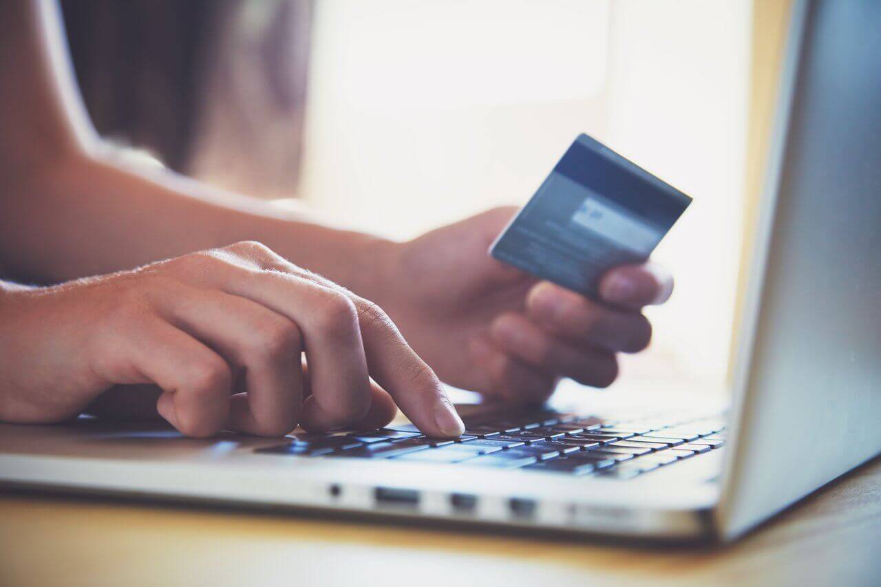 person booking hotel direct online via a laptop