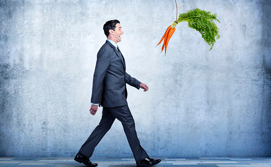 man being led by carrots reflecting the value to hotels of driving direct sales rather than relying on OTAs