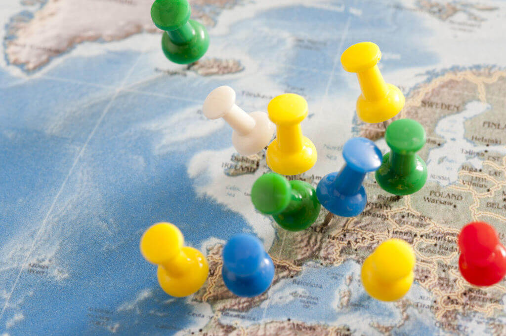 pins in european map highlighting key travel destinations
