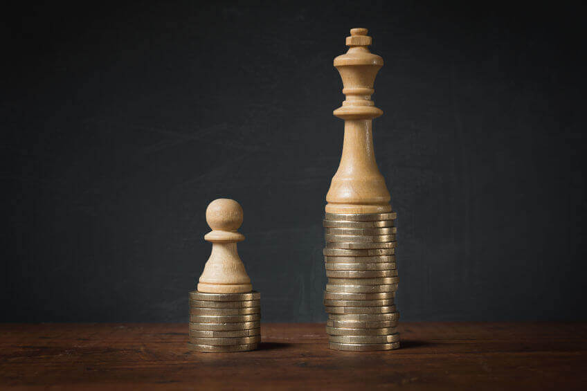 two chess pieces on different stacks of coins showing value of upselling