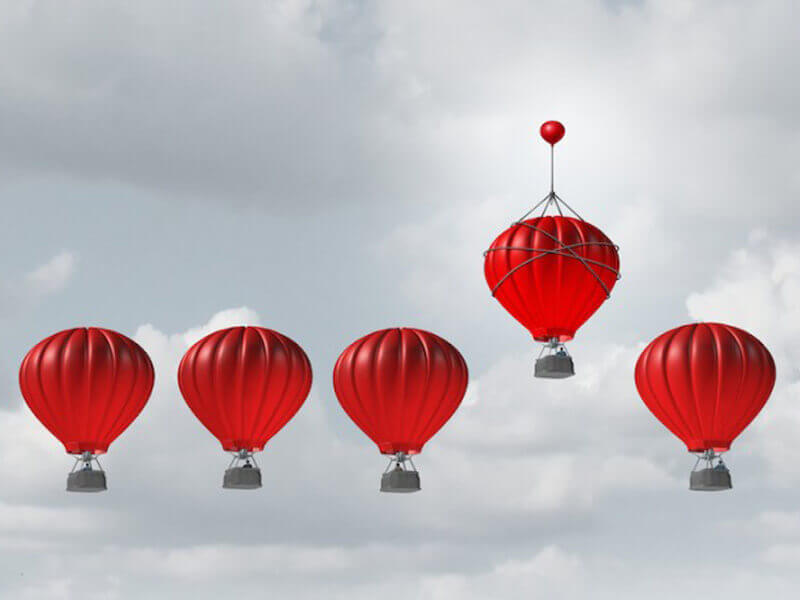 5 balloons with one higher than the other showing benefits of benchmarking