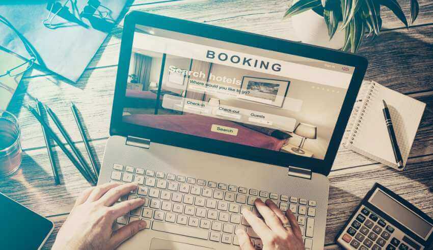 person booking a hotel room on a laptop