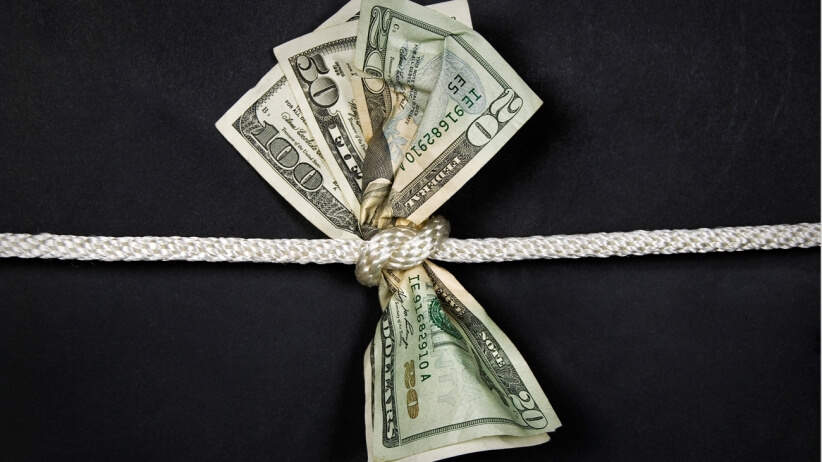 money with rope tied in a knot reflecting importance to manage your marketing budget effectively