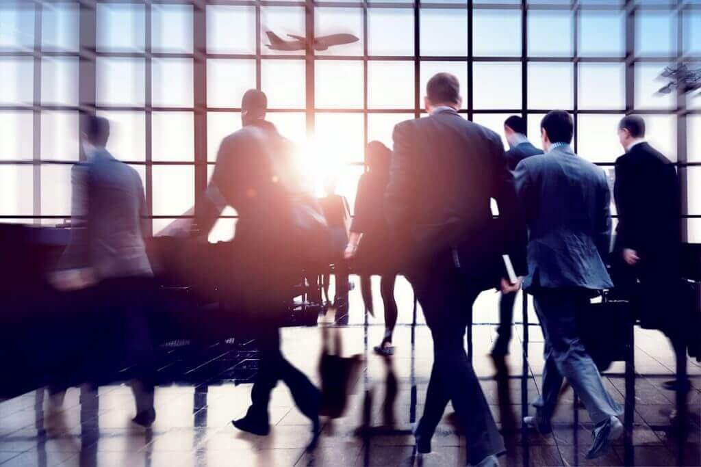 business men in an airport about to travel