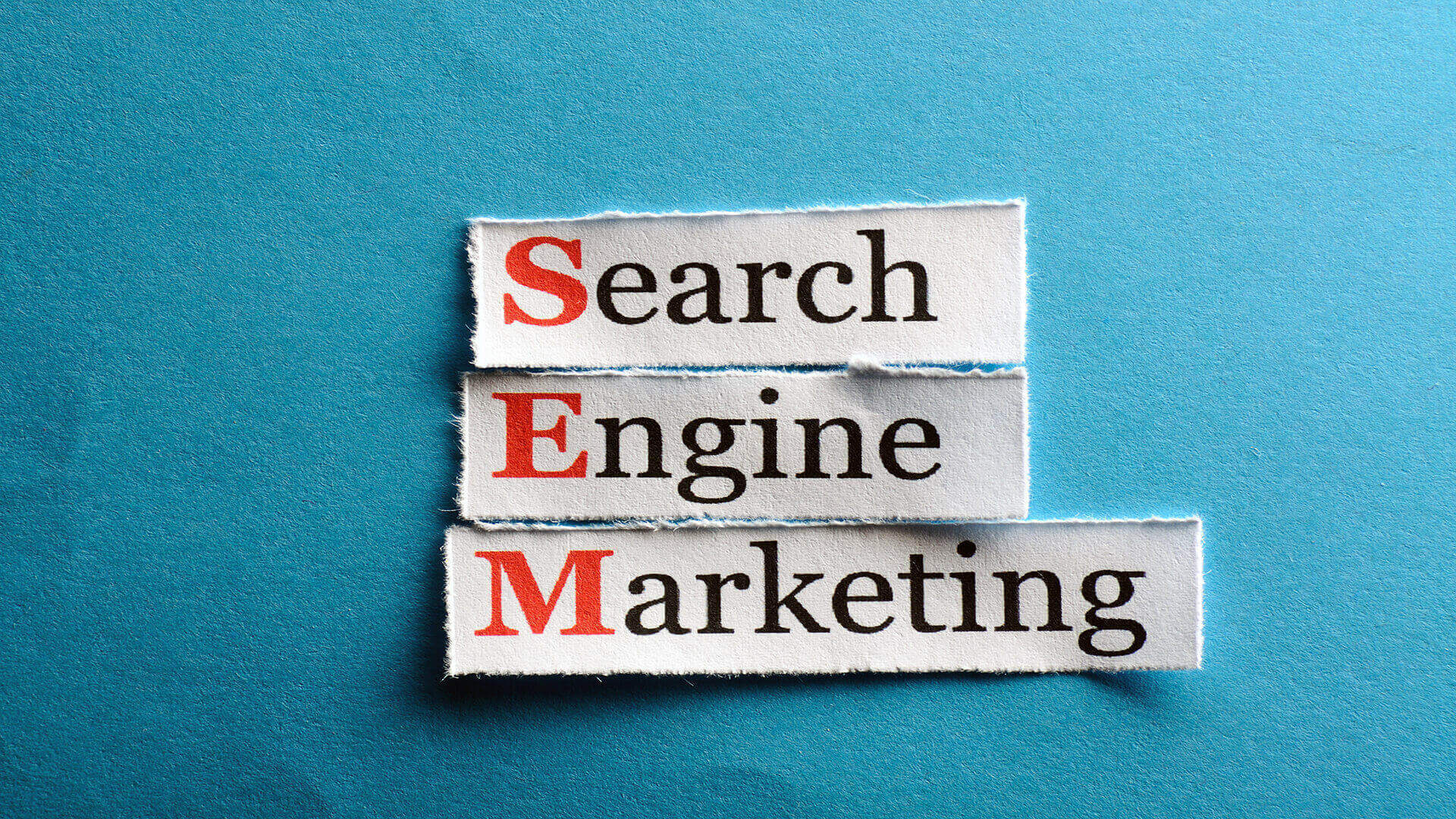 words search engine marketing on a blue piece of paper posing the question sem vs metasearch marketing