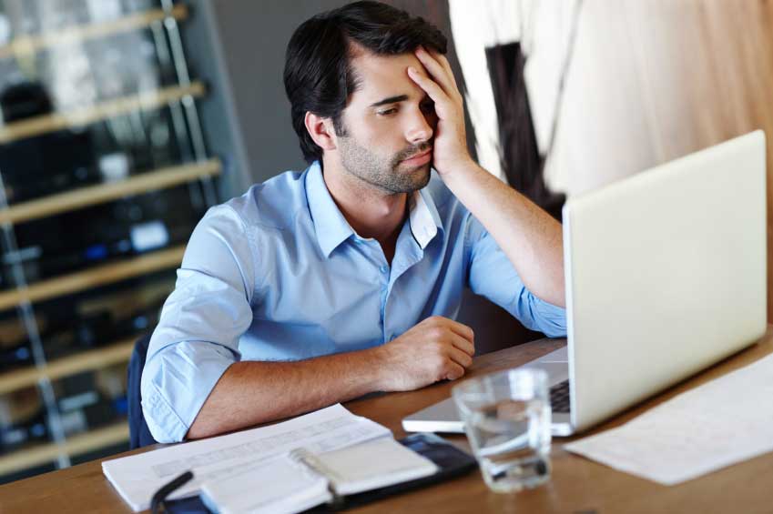 man looking at a hotel website and being unhappy at content