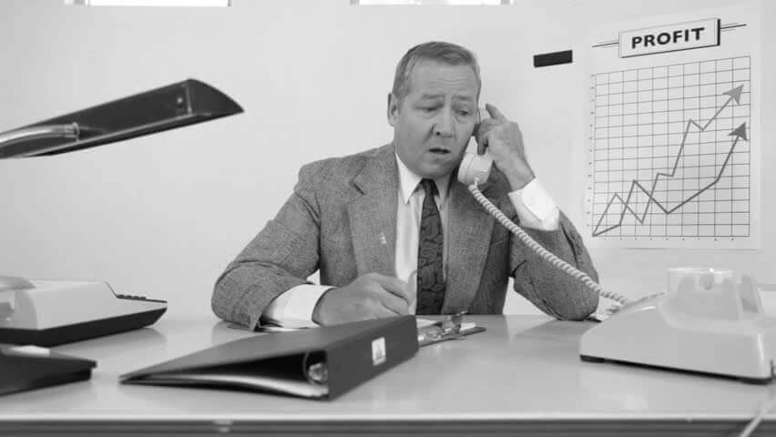 black and white photo of a man on the phone making sales