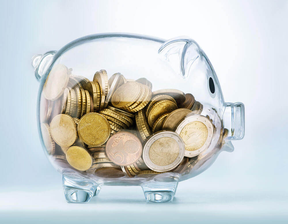 coins in a transparent piggy bank 