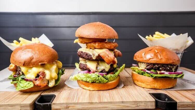 stacked burgers in hotels restaurant of bar