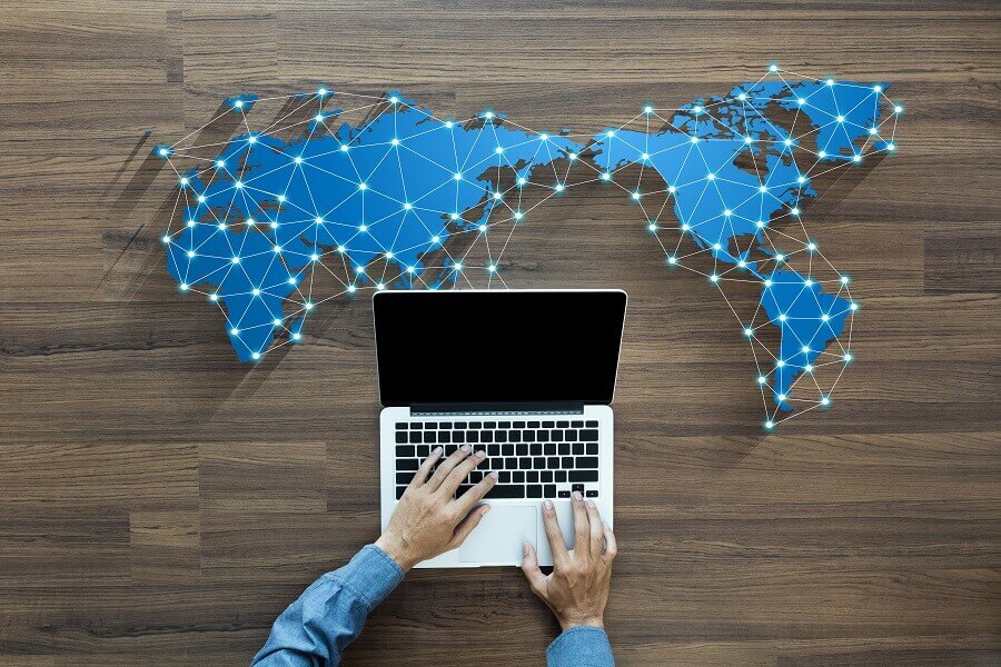 computer and dots showing distribution across globe