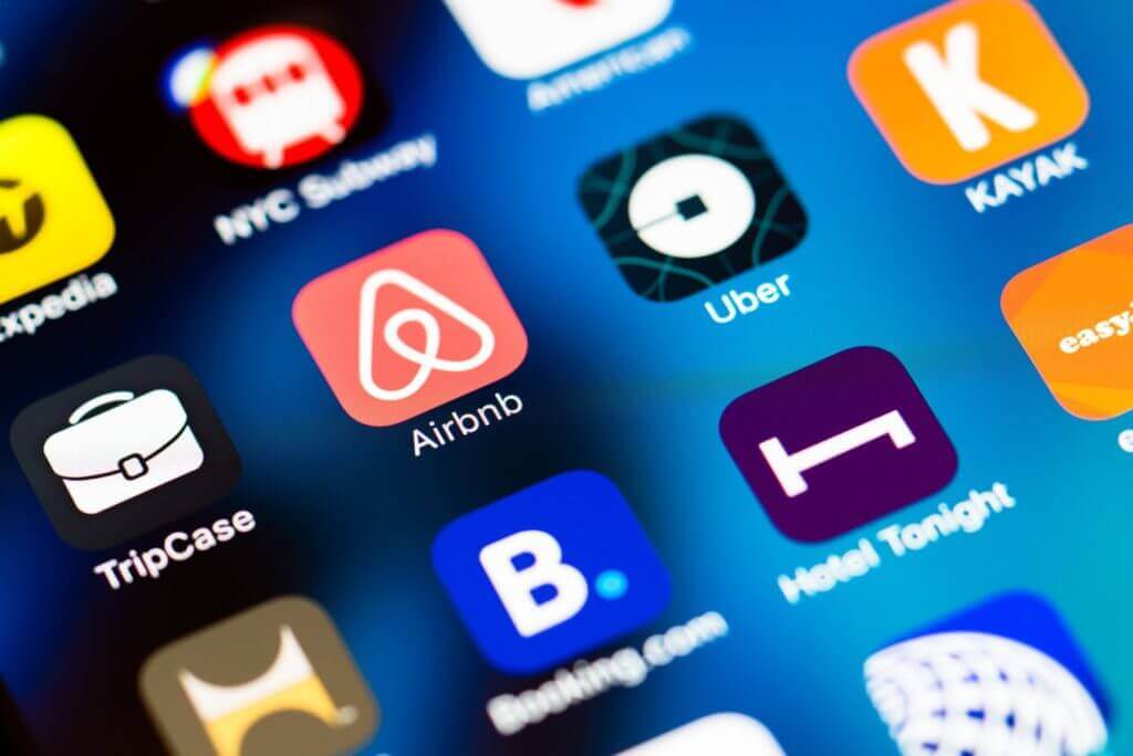 icons of airbnb and booking on a mobile phone