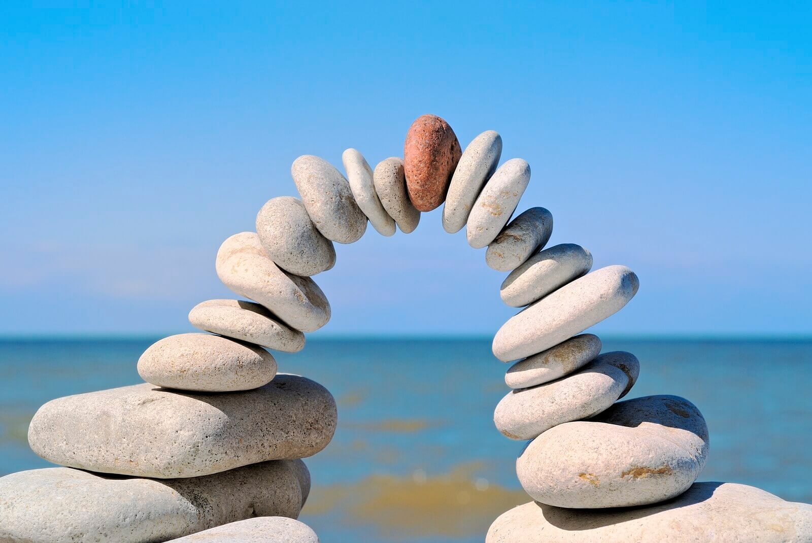 stones balanced together reflecting how revenue optimization is only achieved by working together and breaking down silos