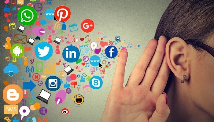 person holding ear with social media icons reflecting impact of viral marketing for hotels