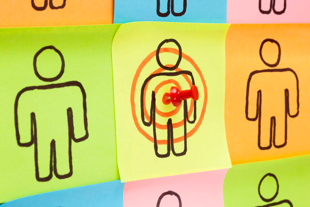 post it notes in different colours with drawing of a man on each with a red pin in a bullseye in the middle post it showing different customer behaviour and how website messages must adapt