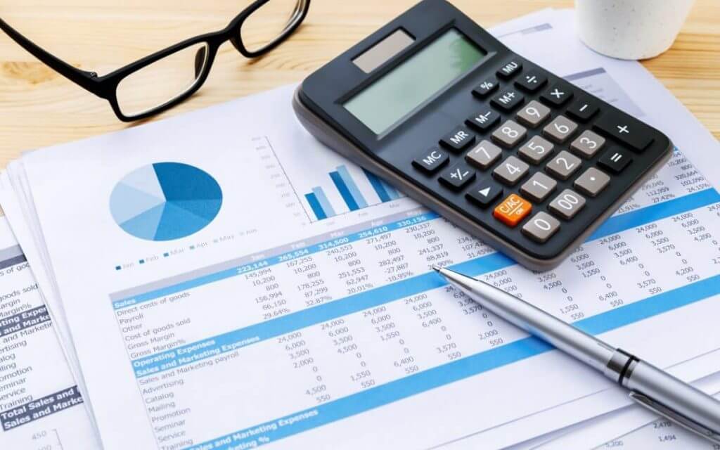 financial statements on a spreadsheet with a calculator