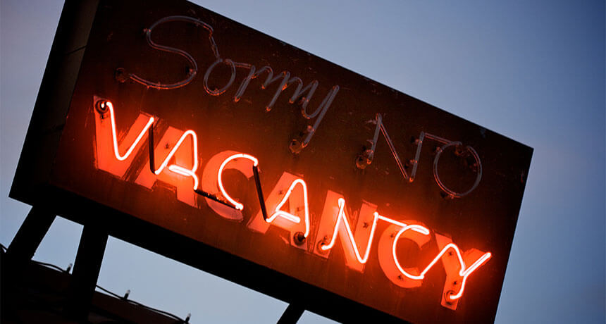 neon light showing room vacancies at a hotel