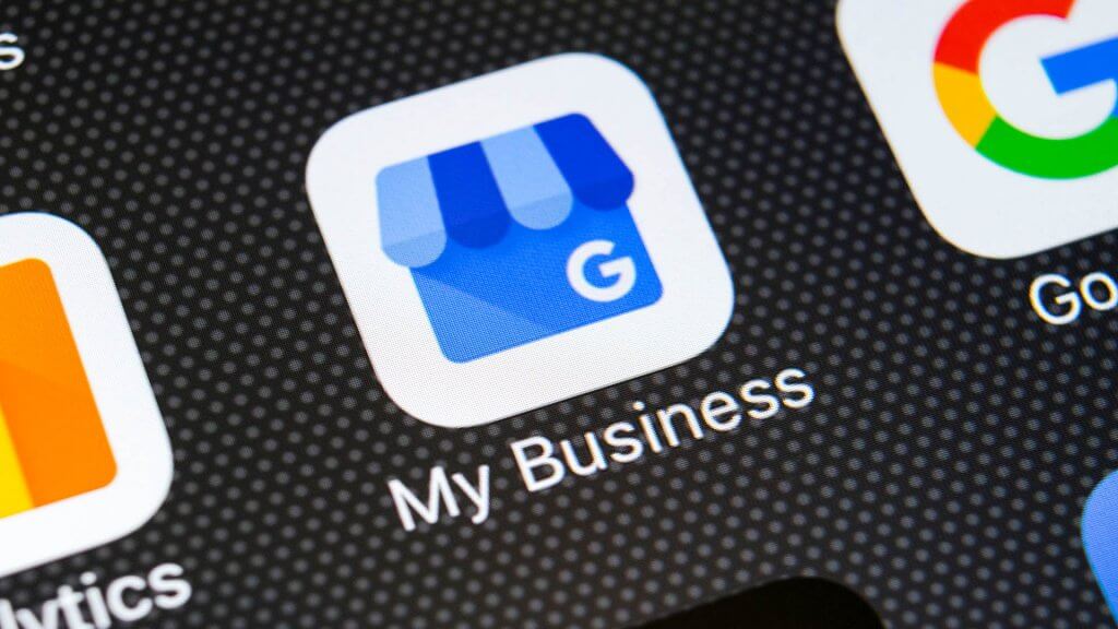 google my business icon on a mobile phone screen which is a valuable addition to a hotel website