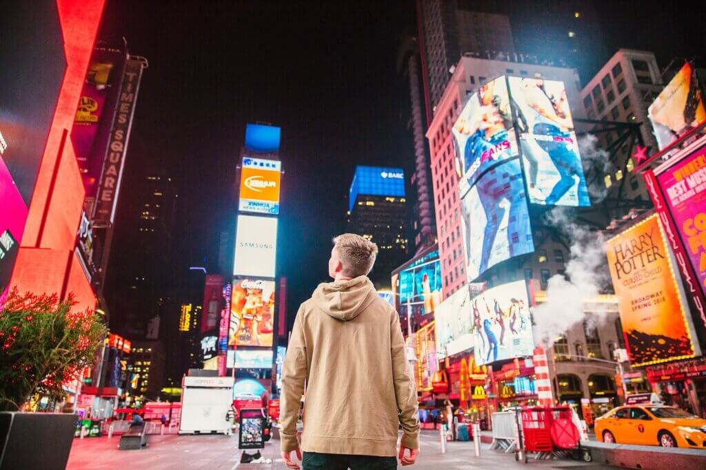 boy looking at billboard advertising reflecting how a hotel needs to evaluate analyze it's demand generation to see campaigns are gaining traction
