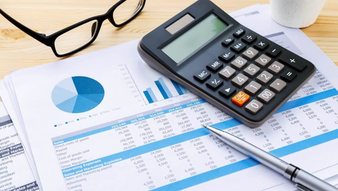 calculator and balance sheet reflecting improtance of a detailed hotel marketing audit