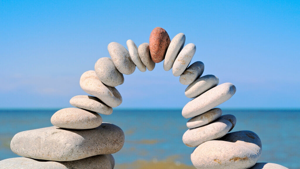 stones balanced in the shape of an arch reflecting changes to sales and marketing teams