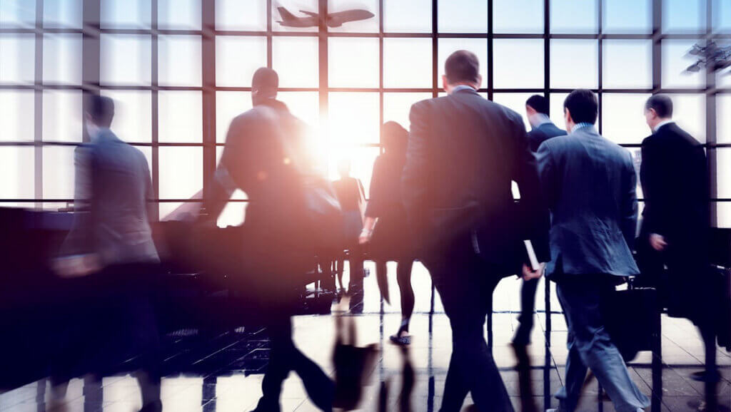 business people at an airport on their way to a group meeting at a hotel