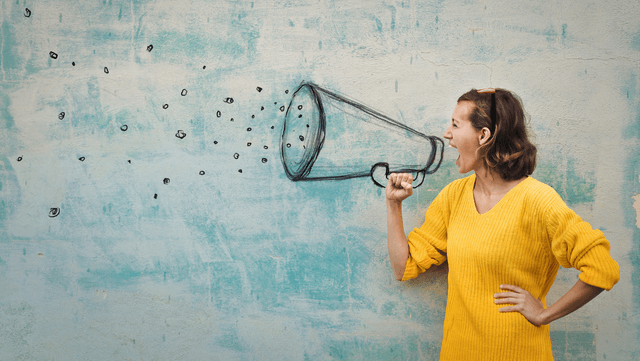 person shouting through a megaphone reflecting the importance for hotels to stay on top of their guest feedback