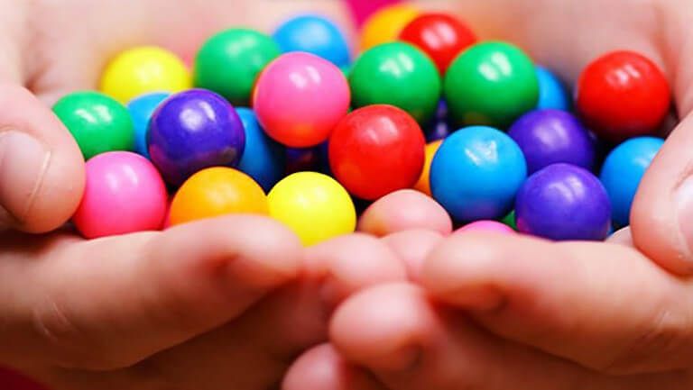 hand holding different coloured balls all mixed up reflecting different hotel demand