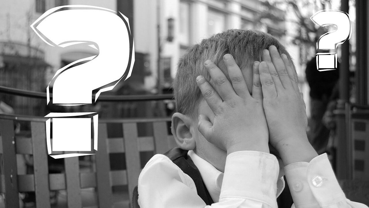 boy with head in hands and question marks reflecting challenge for hotel revenue management