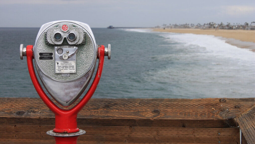 beachside telescope reflecting looking out into the distance in the same way hotels must look to winter 2022 and into 2023