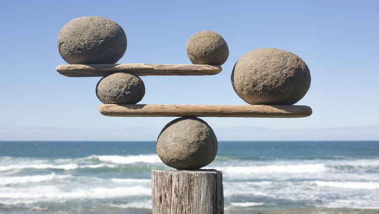 stones balanced on driftwood presenting a holistic vision in much the same way hotels are adopting a holistic commercial revenue strategy