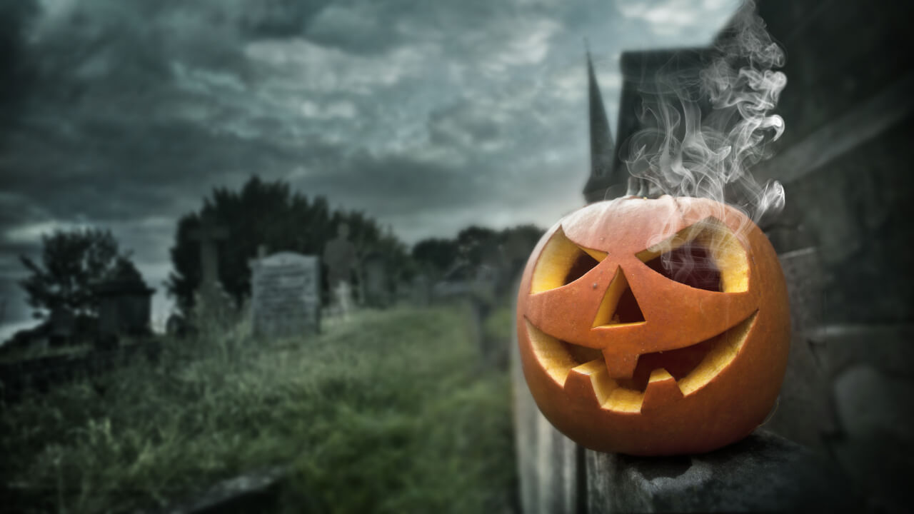 pumpkin in a graveyard reflecting need for hotels to start quickly actioning their Halloween marketing plans