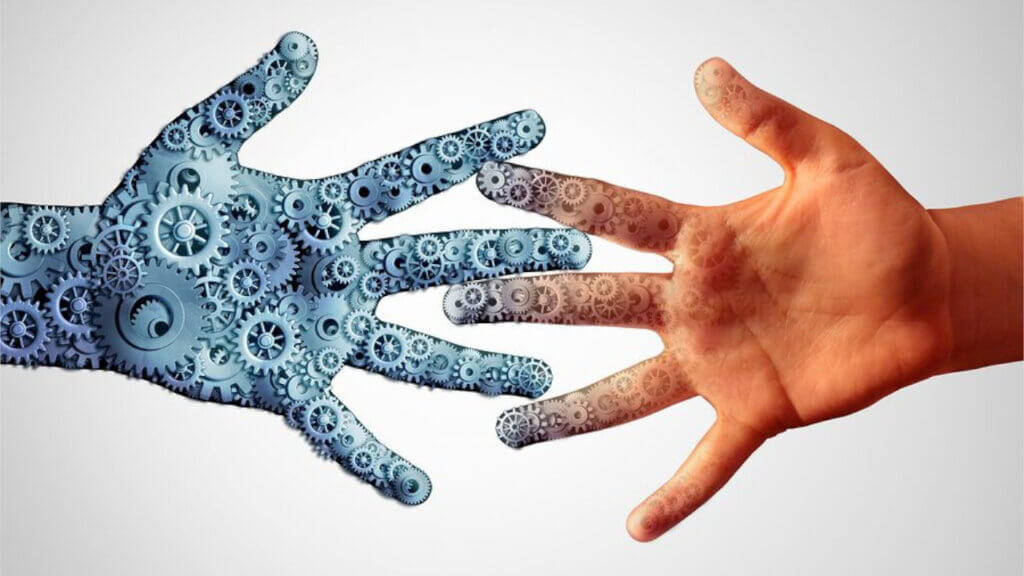 a human hand reaching out to a technology hand reflecting how digital hospitality is blending human touch and technology to improve guest experience
