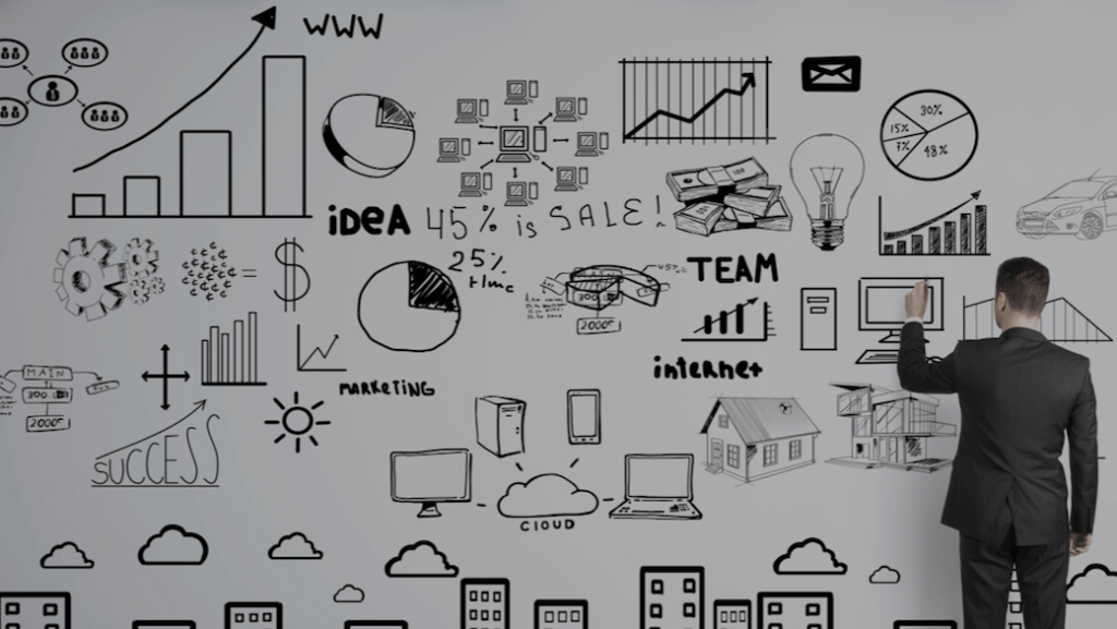 man by whiteboard with graphs and charts reflecting different hotel rate strategies