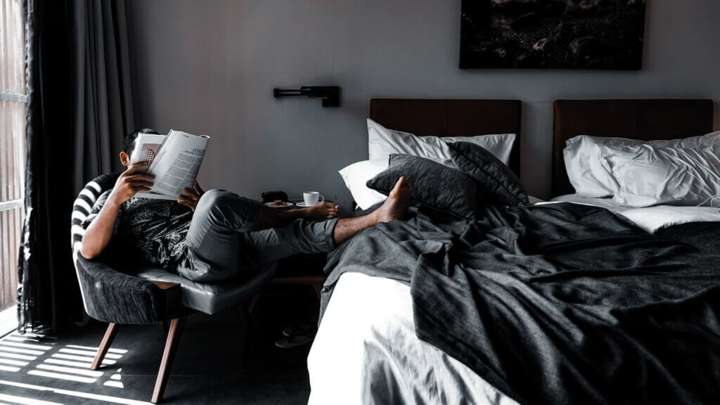 man resting in day use hotel accommodation