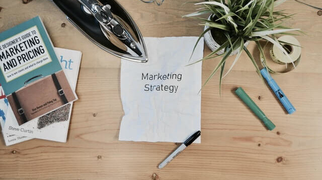 paper with the word marketing strategy written on it
