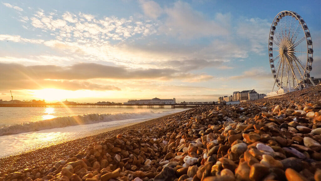 hotels along a seaside shoreline with sun coming up indicative of recovery in room rates 