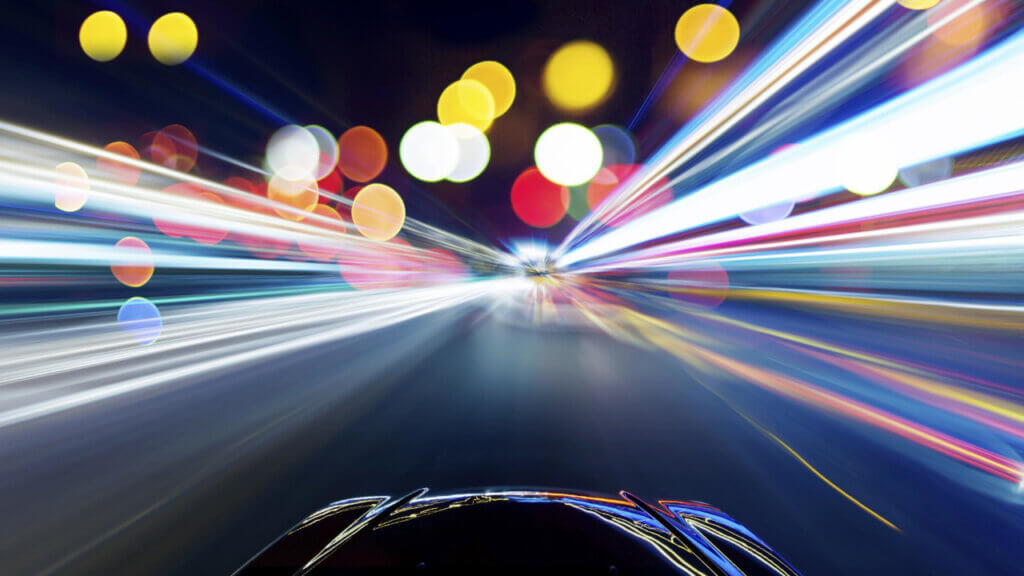 front of a car going fast with blurred street lights reflecting importance of driving more traffic to your website