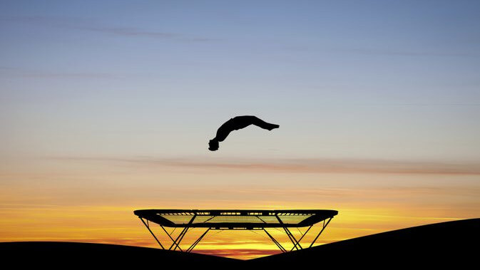person on trampoline flipping over reflecting digital marketing mega trends that will turn business on it;s head