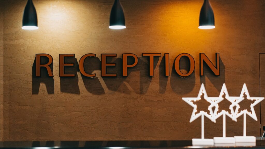 hotel reception and 3 stars on the front desk, possibly reflecting the quality of the offering and guest reviews which can impact revenue
