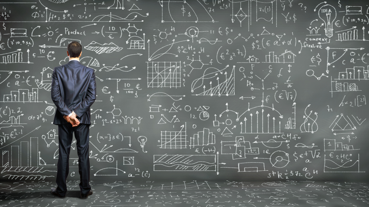 man standing in front of calculations and algorithms reflecting the need to unlock efficiency and revenue utilising deep q learning with batch constraints