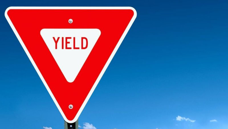 triangle sign with the word yield spelt out reflecting the need to understand the difference between yield management and revenue management