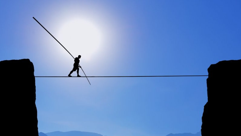 tightrope walker reflecting challenge for hotels of balancing whether to sell out or maximize revenue