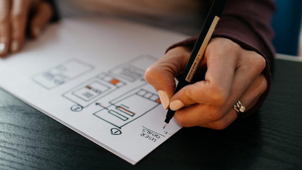 person drawing out a website design to drive direct bookings in a competitive market for hoteliers through the utilisation of hotel website forms