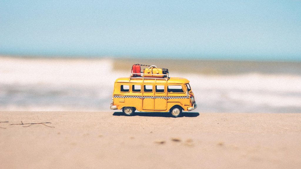 campervan on a beach reflecting increase in digital nomads and their impact on travel