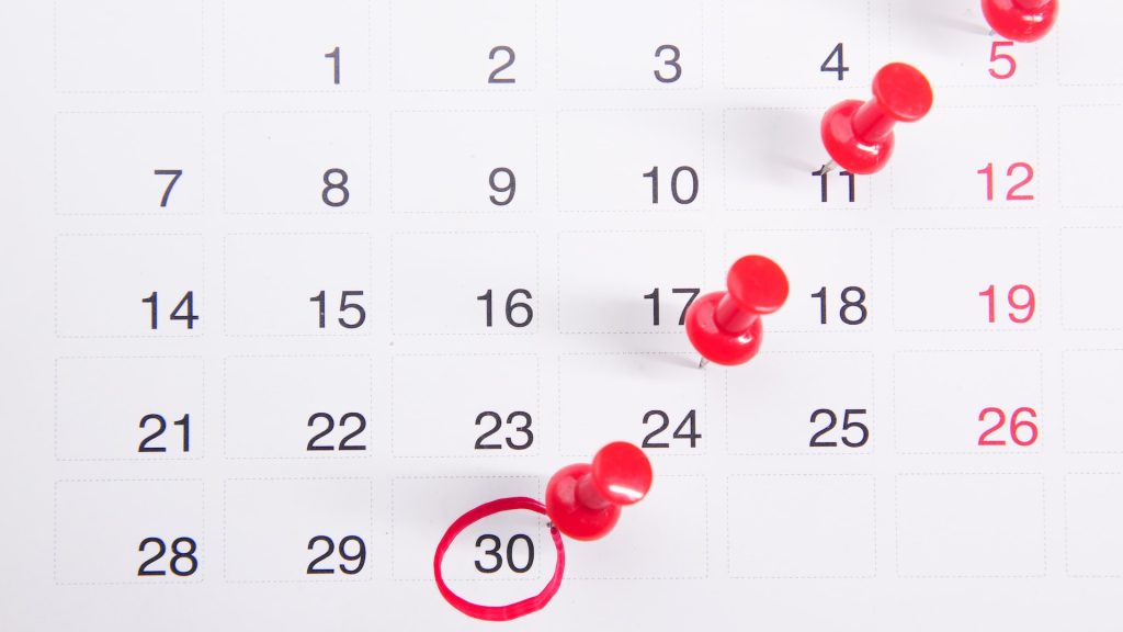 calendar with pins and a date circled reflecting the importance for hotels to review and then plan their social content calendar