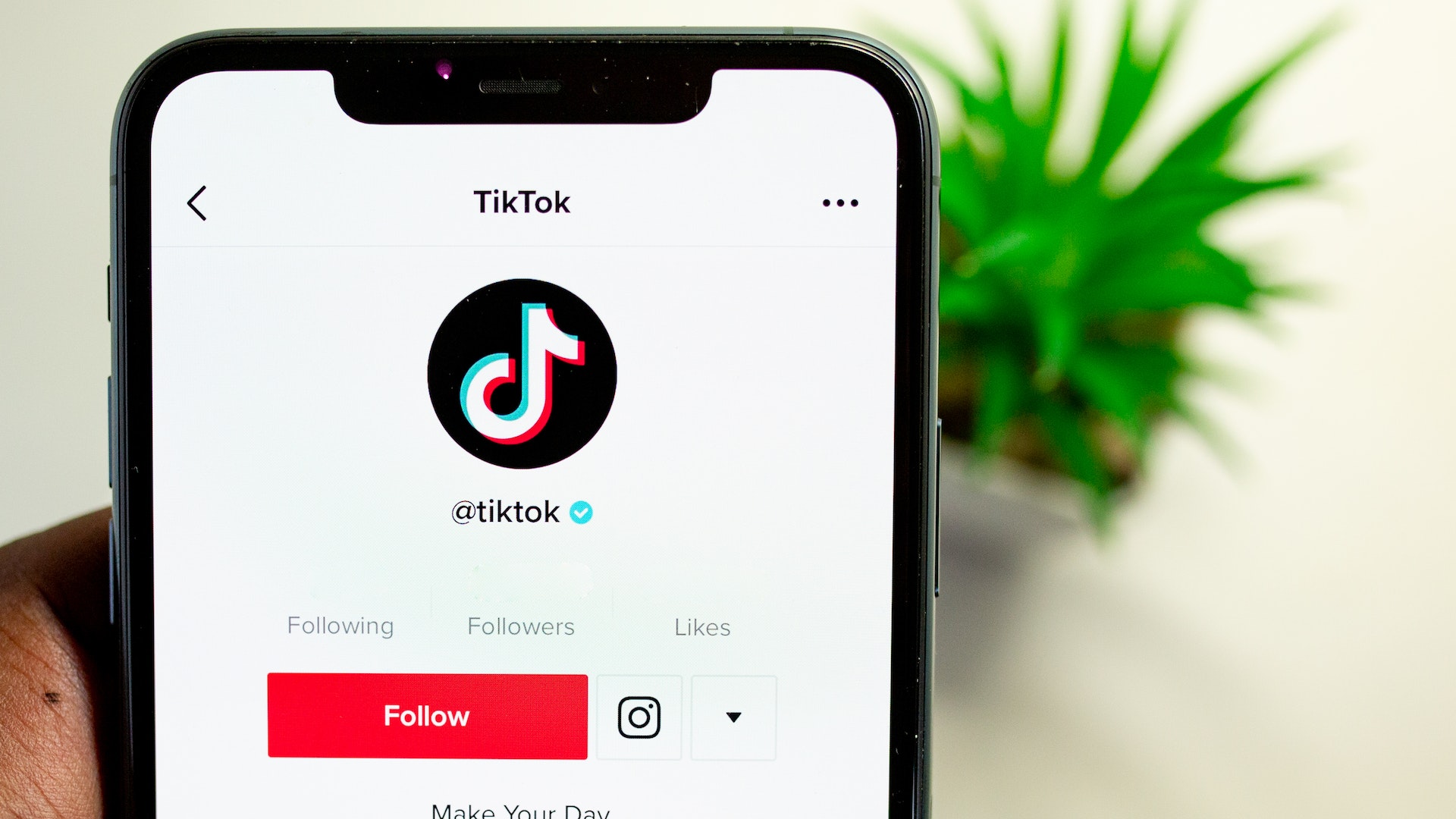 tiktok logo and follow button on mobile phone reflecting importance to hotels of their new search ads feature