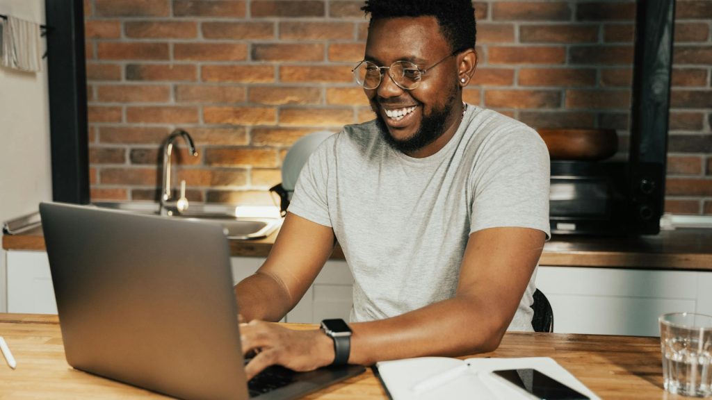 man on laptop possibly having a positive guest experience as they start their travel journey through booking online