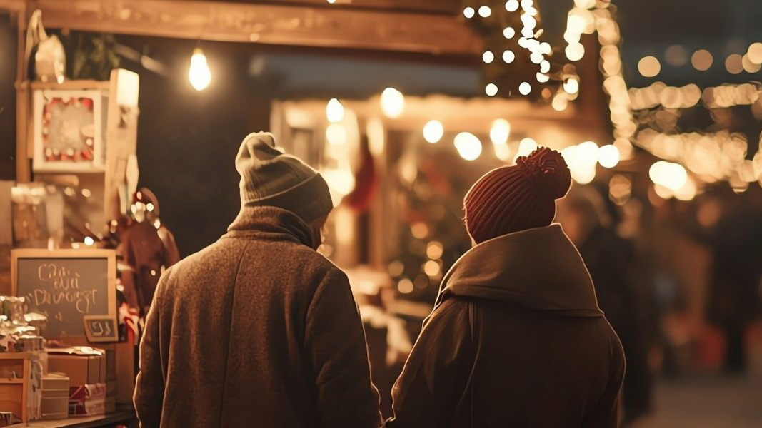 2 people at a christmas fair reflecting importance of email to sleigh hotel sales this holiday season